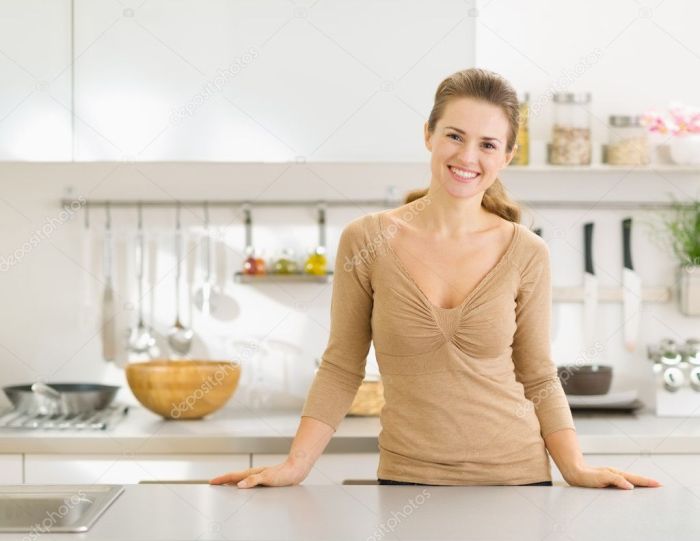 Housewife young mixing salad smiling kitchen stock